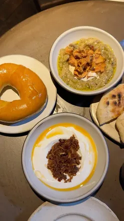 Delicious spread of salt cod, spanakopita, charred squid, and oxtail giouvetsi at OMA London, Borough Market.