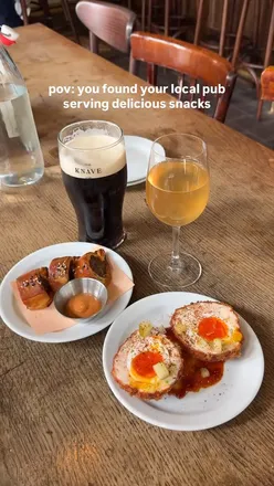 Prawn scotch egg and lamb sausage roll at a Shoreditch pub, showcasing delicious pub food and drinks.