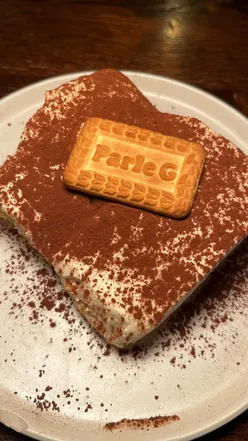 Chai tiramisu dessert from East West London, showcasing layers of creamy goodness and aromatic spices.