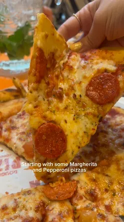 Delicious bottomless pizza and spritz pitchers at Doughnation Pizza in Covent Garden, perfect for a fun night out.