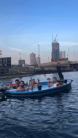 Enjoying a unique floating hot tub experience in London, cruising through Canary Wharf at 38°C with drinks onboard.