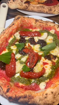 Delicious wood-fired pizza from Grande Pizzeria, a favorite spot in the northeast for authentic Italian cuisine.