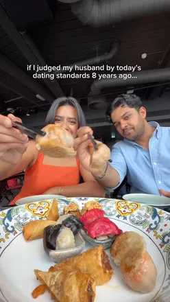 Couple celebrating their anniversary at Hutong Shard, enjoying a stunning dim sum platter with a beautiful London view.
