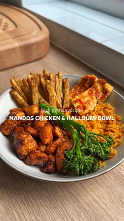 Healthy Nandos chicken and halloumi rice bowl with peri peri chips, packed with 63g protein and vibrant veggies.