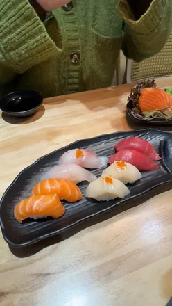 Delicious sushi and ramen shared among friends in London, highlighting Japanese cuisine and local food culture.