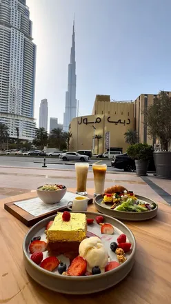 Golden Royal French toast and breakfast croissant at Hampstead Bakery, with Burj Khalifa view in Dubai.