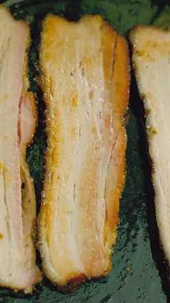 BLT sandwich with smoked pork belly at a sandwich shop, featuring crispy bacon and fresh ingredients.