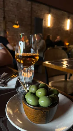 Enjoying delicious wines and small plates at Chinchin MCR wine bar in Manchester, with a vibrant ambience.