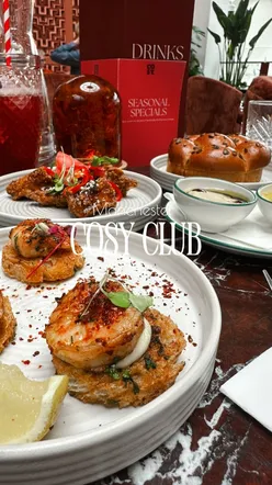 Luxurious Cosy Club bar in Manchester with gourmet dishes like Burrata salad and Pisco Sour cocktails.
