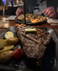 Delicious Spanish cuisine in Mallorca, featuring juicy steak and flavorful paella.