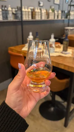 Group enjoying a rum tasting at Salford Rum, featuring cocktails and personalized wax-sealed bottles in Manchester.