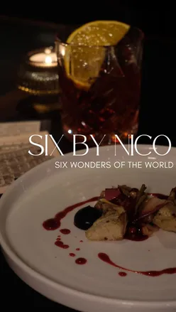 Diners enjoying Six by Nico's immersive tasting menu inspired by the Wonders of the World in Birmingham.