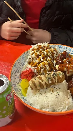 Child enjoying fresh sushi at Kyuri Sushi Stroud and cherry bubble tea with rainbow boba at Five Valleys, Stroud.