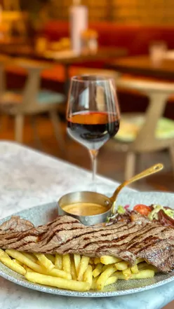 Delicious Steak Frites with peppercorn sauce and a glass of wine at Rabble Edinburgh for £15.