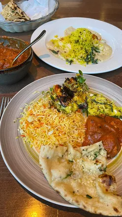 Delicious Indian meal at The Mint Room in Bath: curry, vegetarian platter, naan, and carrot pudding dessert.