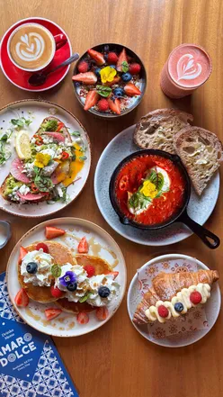 Delicious brunch dishes at Amaro Dolce in Battersea, featuring pancakes, avocado toast, and a pistachio latte.