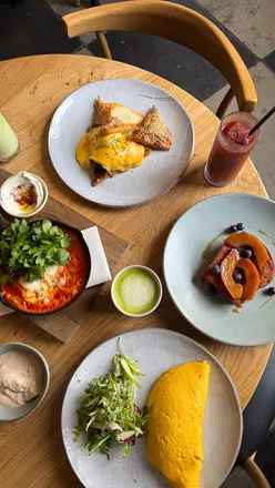 Mediterranean brunch at Claro London featuring crab omelette, shakshuka, and French toast with blueberries.