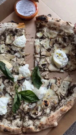 Truffle and burrata pizza with wild mushrooms on a pesto base from Franco Manca Pizza in Cheltenham.
