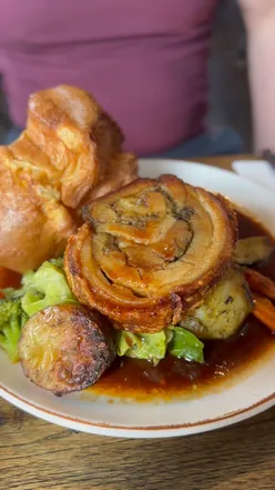 Beef and pork belly roast dinner with cauliflower cheese and pigs in blankets at Button Factory Birmingham.