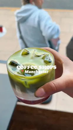 A cozy Manchester coffee shop scene featuring delicious coffee and a vibrant city atmosphere.