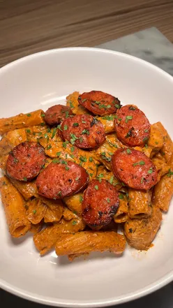 Delicious chicken and chorizo rigatoni pasta dish garnished with parsley, perfect for home cooking inspiration.