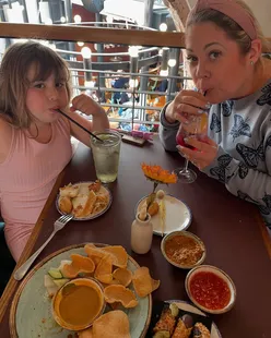 Busy Leeds food hall with families, serving beer, tacos, coffee, cake, margarita pizza, mini gnocchi, salted steak, and tiffin.