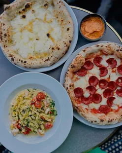Neapolitan pepperoni pizza with N'Duja mayo, garlic bread with cheese, and king prawn linguine at Il Capitanos, Waterloo.