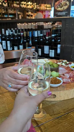 Sicilian wine tasting with hams, cheeses, and tiramisu at Veeno, showcasing delicious pairings and flavors.