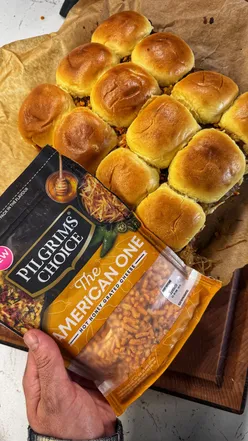 Smoked beef French dip sliders topped with Pilgrim's Choice Hot Honey Grated Cheddar cheese.