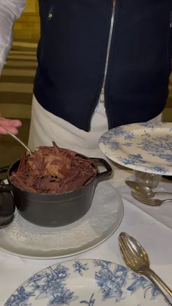 Giant chocolate mousse dessert at Le Bon Georges in Paris, topped with chocolate shards, perfect for sharing.