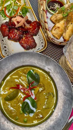 Delicious Thai dishes at Giggling Squid Leeds: crispy duck spring rolls, pork belly, green curry, and rotis.
