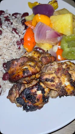 Jerk chicken tray bake with rice and peas, perfect for a dinner party crowd-pleaser.