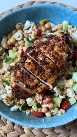 Couscous salad topped with spicy Cajun chicken, perfect for a flavorful lunch or dinner recipe.