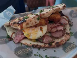 Full English breakfast in pizza dough flatbread with Fior di Latte at Cofton on the Green, enjoyed after Lickey Hills walk.
