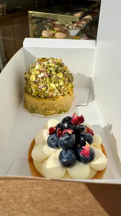 Delicious pistachio mousse and fresh fruit tart at Savour Bake Cafe in Gateshead, showcasing sweet treats and pastries.