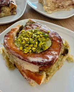 Pistachio cinnamon roll from Cinnaroma Bakery in Loulé, Portugal, near Faro, with a cozy market and castle visit.