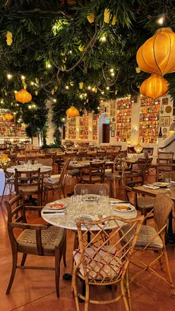 Circolo Popolare Manchester restaurant with jasmine ceiling, vintage bottles, hand-painted crockery, pasta bowls, lemon meringue pie.