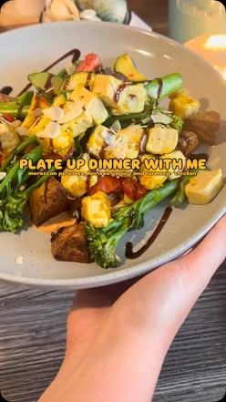Moroccan loaded potatoes with air-fried garlic herb potatoes, turmeric cumin chicken, steamed broccoli, harissa yogurt, balsamic glaze, almonds.