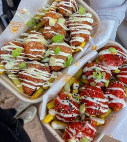 Garlic butter parmesan and spicy buffalo chicken nuggets with blue cheese at Peddler Market, Tileyard North, vibrant atmosphere.