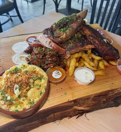BBQ platter at Firehouse, Glasgow: dino rib, baby rack ribs, smoked sausage, pork belly burnt ends, beer can smoked chicken, garlic parmesan fries, mac & cheese, corn ribs.