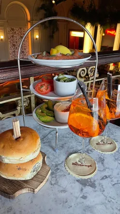 Aperol Afternoon at The Marlborough: Aperol Spritz, customizable bagel tower with smoked salmon, and mini desserts in a chic venue.