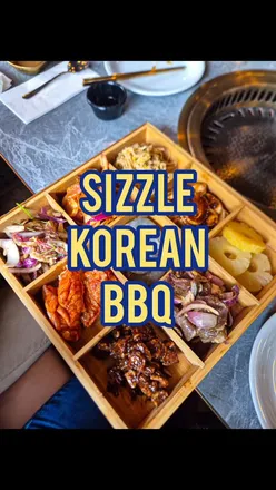 Korean BBQ platter with meats and non-meats at Sizzle Korean BBQ, Glasgow West End; cozy, clean atmosphere.