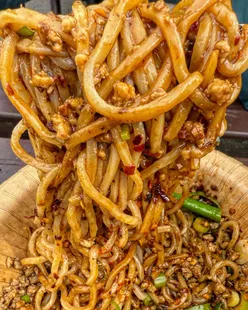 Heavenly Dan Dan noodles with juicy pork mince, spring onions, chili, and peanuts at The Garage Chilwell, Nottingham.