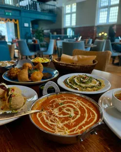Sarthi restaurant in Bath's Walcot Street offers vegan Indian dishes in a historic church setting, featuring papadum, samosa chat, masala dosa, and mango kulfi.