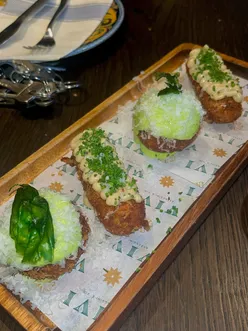 Cheesy bufalina pizzette, spicy bomba arancino, cacio e Pepe croquettes, and focaccia at Vivi Liverpool restaurant.