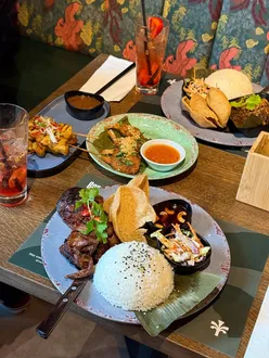 Southeast Asian dishes at Banana Tree Cardiff: Katsu Curry, Beef Rendang, Pad Thai, with rainforest vibes and vibrant cocktails.