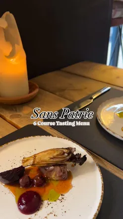 Six-course tasting menu at Sans Patrie: Burrata with pistachio, Duck with cherry, Sea Bass with squid, Lamb Fillet with panzanella, Chocolate Delice with mango, paired with wines like Sauvignon Blanc and Pinot Noir.