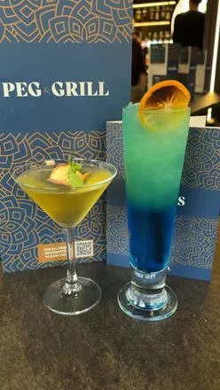 Peg & Grill Birmingham: Appletini, Cosmopolitan, Blue Lagoon cocktails; large mixed grill, chilli garlic prawns, keema pizza, butter chicken, Punjabi lamb curry, garlic naan, pilau rice, malai kulfi.