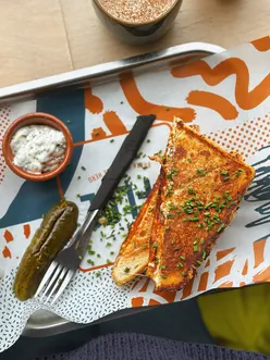Grilled cheese sandwich with melted cheese at Ffloc Cymru in Canton, offering comfort food therapy for hangovers.