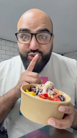 Chaunsa mango dessert with soft serve ice cream, British strawberries, berry compote, white chocolate, bubblegum sauce, and digestive crumbs.